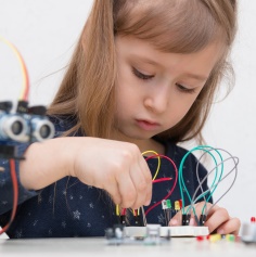 Female child playing with child's engineering kit