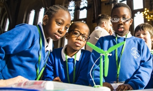 Group of children looking at a science experiment