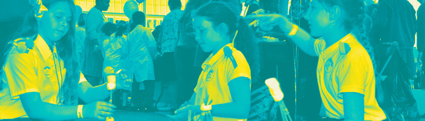 Three female primary school students building structures from marshmallows and spaghetti