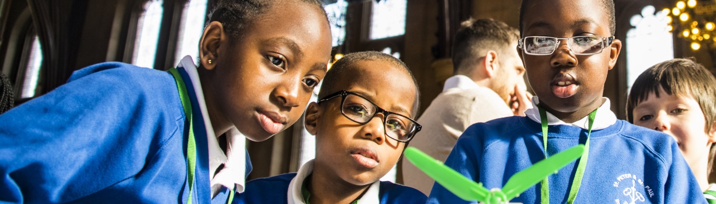 School children watching science experiments 